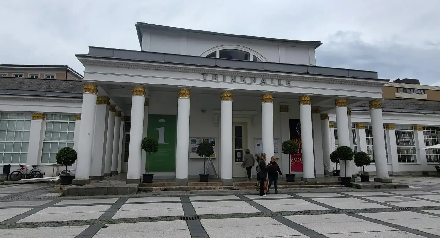 the old Trinkhalle, an impressive historic white building constructed in the style of a Greek temple