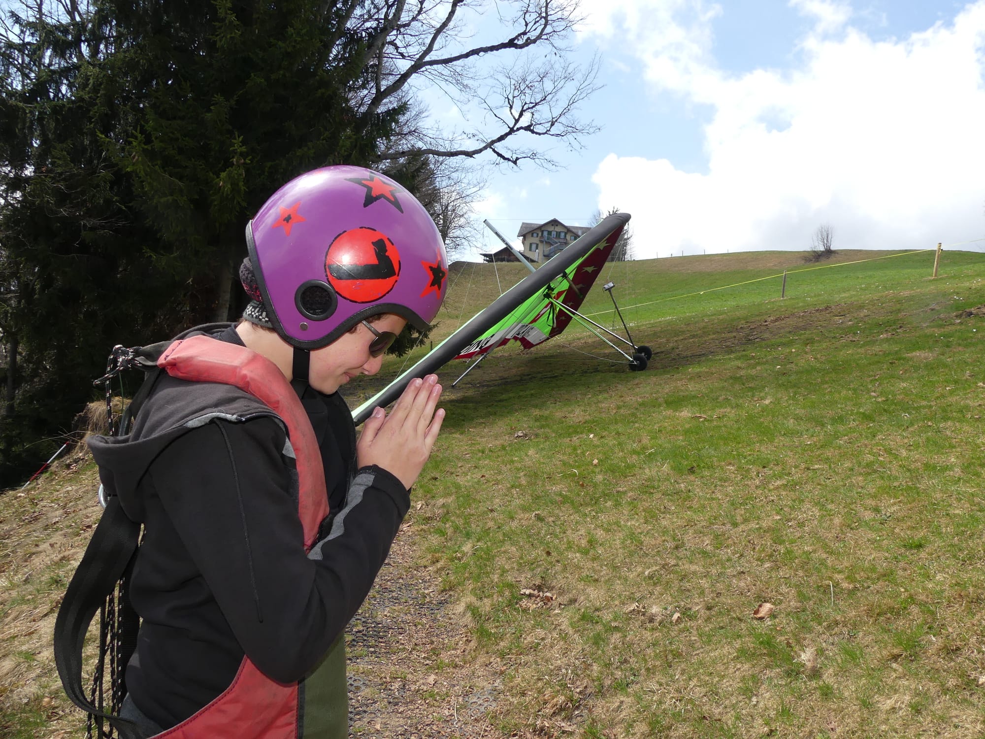 Standing next to the hang glider while praying