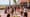 Tourists crowd Ocean Drive in Miami Beach with busy cafés, palm trees, and Art Deco hotels