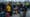 Passengers queuing in Bournemouth Airport departure hall with strike notices on check-in screens