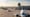 Several aircraft queue on a European airport taxiway in summer sunlight, showing busy air traffic operations.”