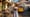 Solo traveler in Lisbon with camera and guidebook as tram passes in summer 2025